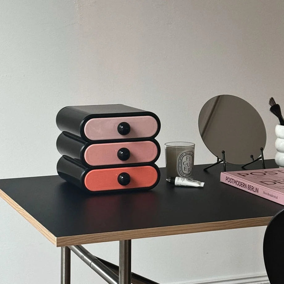 Glossy Wavy Color Block Makeup Organizer on a black desk with a candle and mirror. - RoomDen