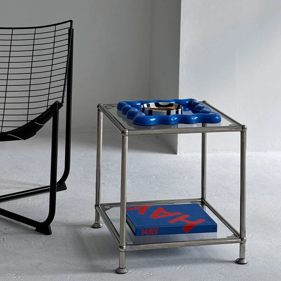 Cobalt Blue wavy tray on a glass and chrome side table in a modern living room - RoomDen