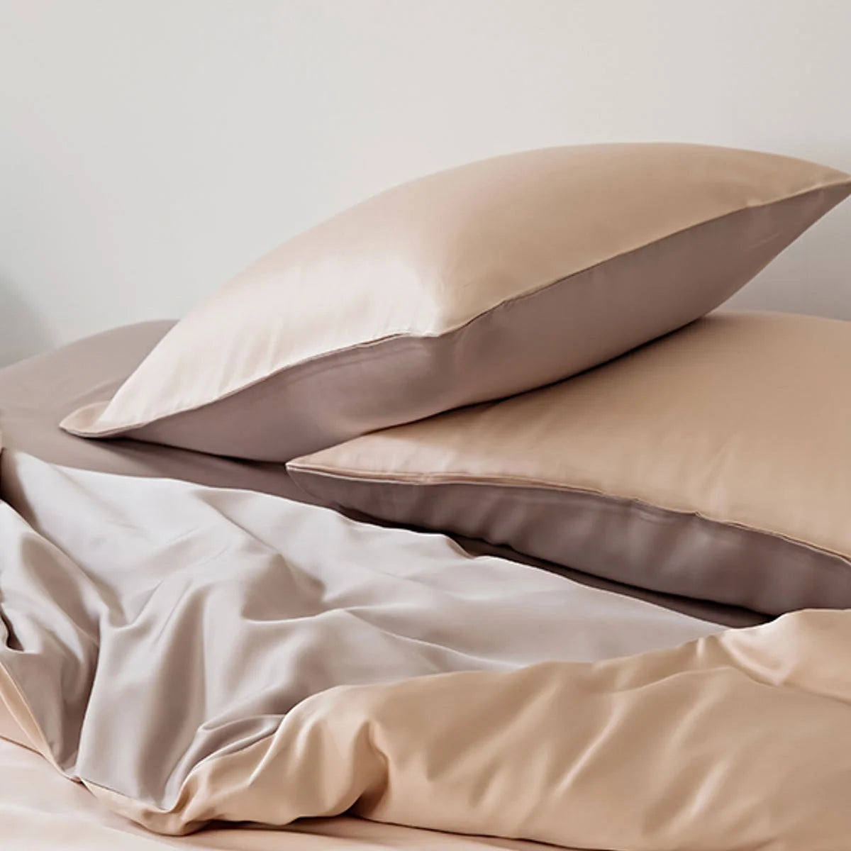 Close-up of the layered pillowcases in Peach & Taupe Tencel fabric.