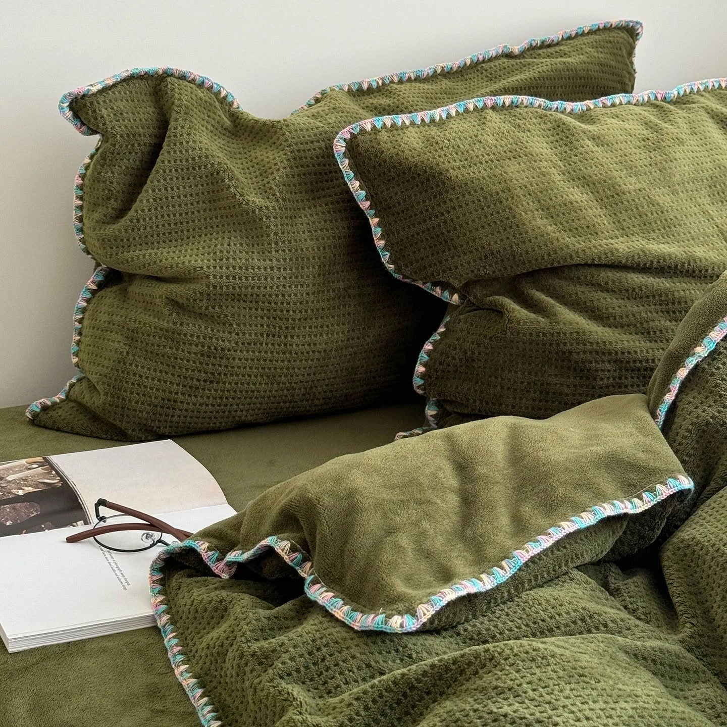 Close-up detail of the colorful crochet trim on the Olive Green flannel fleece pillowcases.