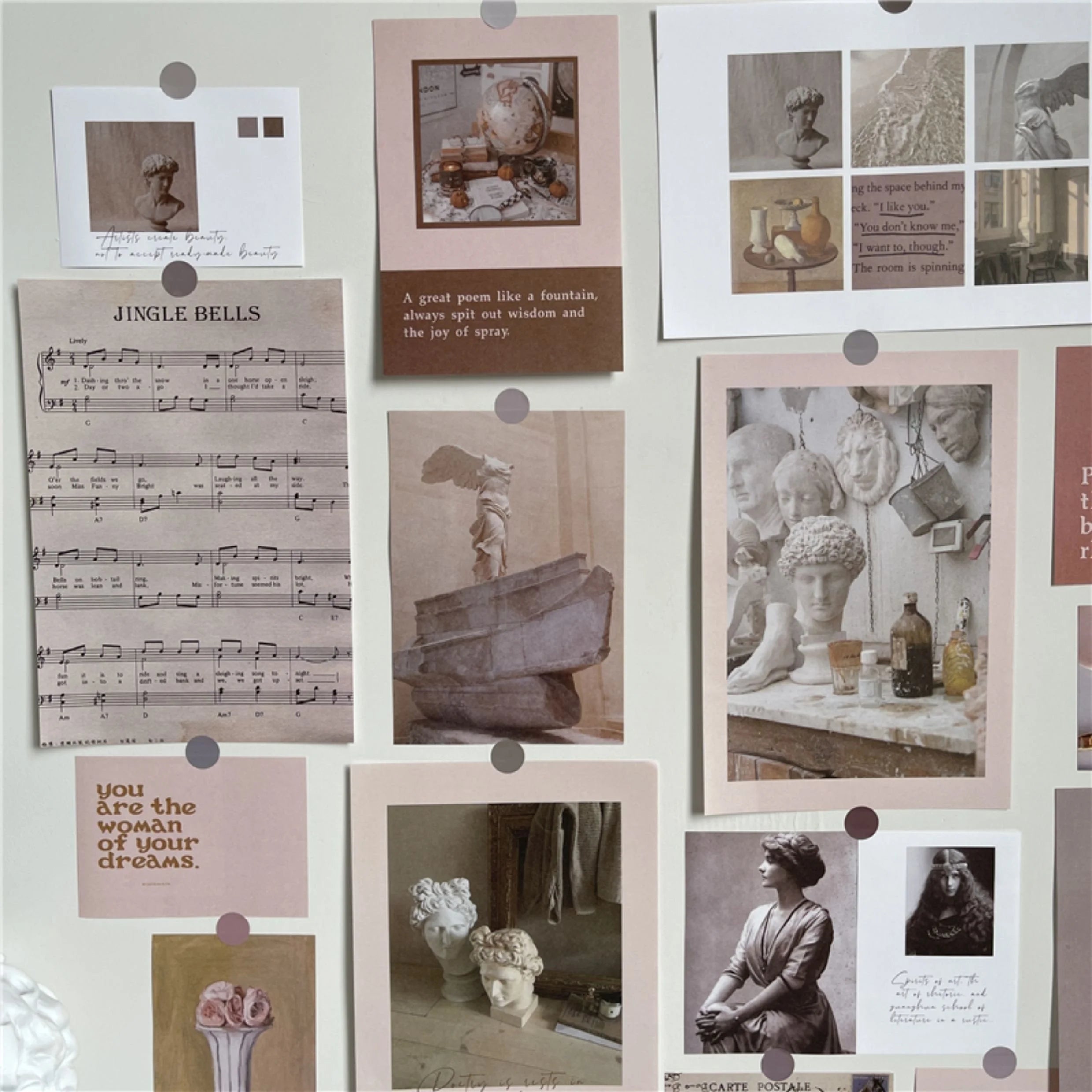 Close-up view of the Vintage Academia wall collage kit, showing details of the sheet music and classical sculpture prints.