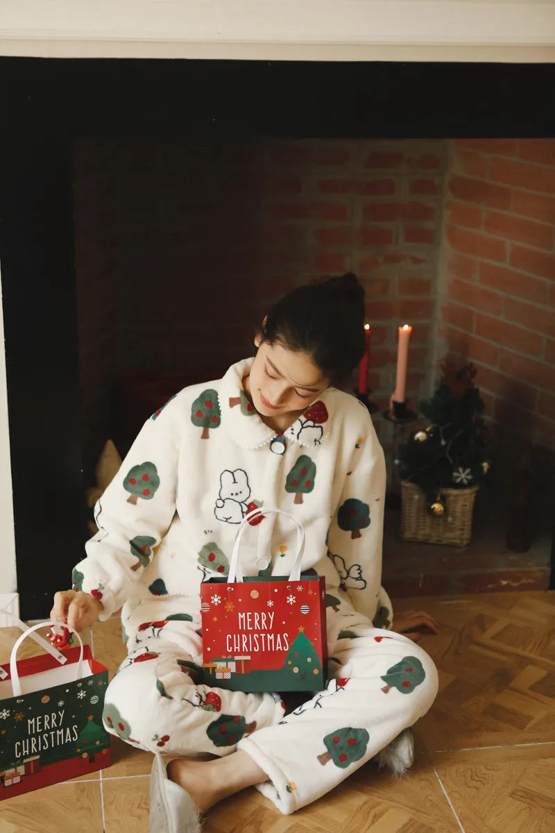 Woman opening Christmas gift wearing White Flannel Fleece Pajama with Bunny Print