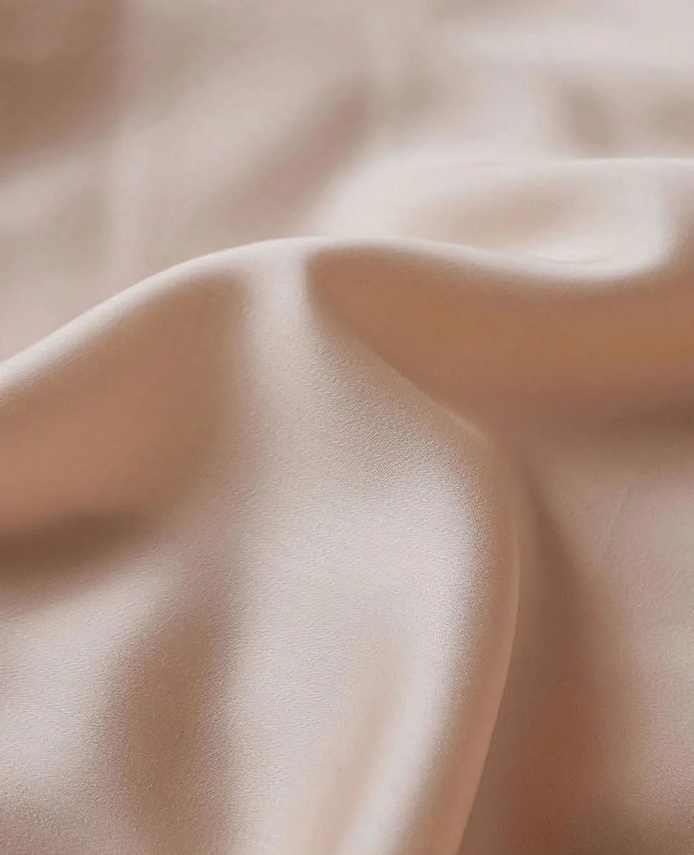 Extreme close-up of the smooth, silky texture of the Cooling Tencel fabric in Blush Pearl. - RoomDen