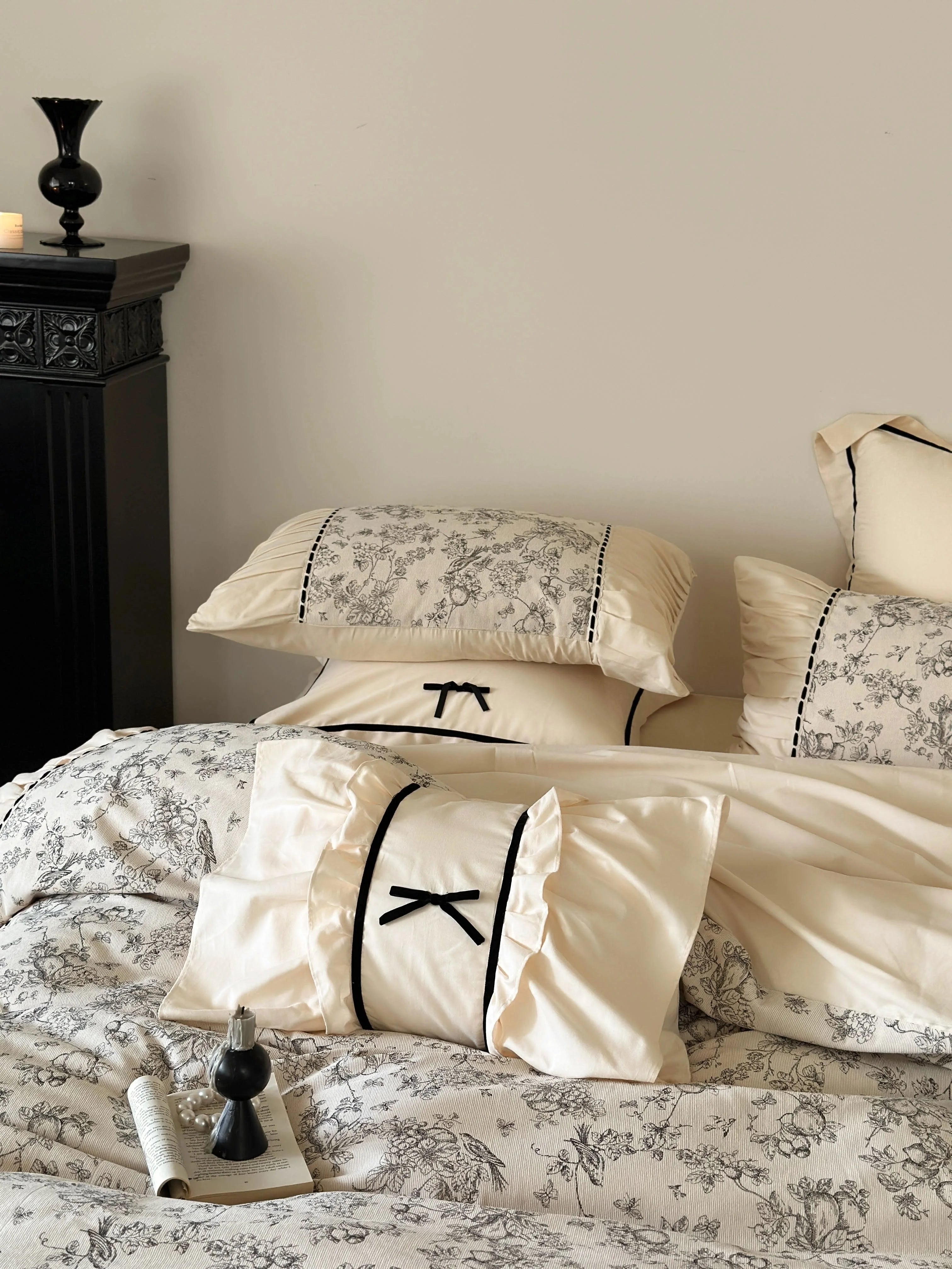 Focus on the ruffled pillow shams and bow accent pillow of the Cream Toile bedding set. - RoomDen