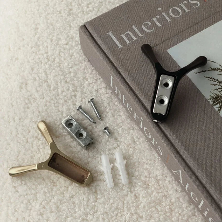 Detail shot of installation hardware for the branch-shaped hooks, showing the gold and black hooks with mounting plates and screws - RoomDen