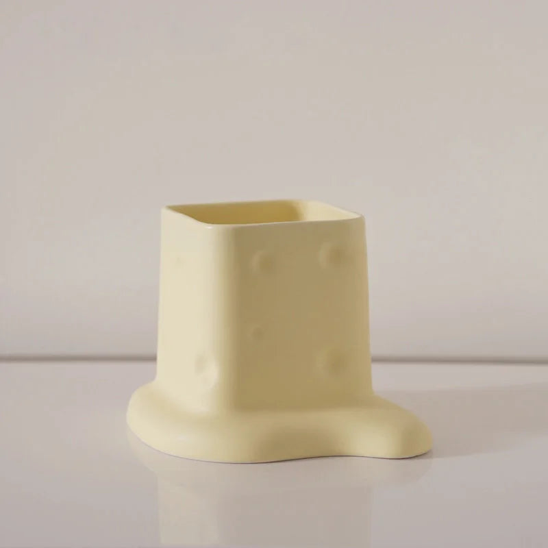 Close-up of the Butter Yellow melting cheese ceramic desktop organizer on a white background. - RoomDen