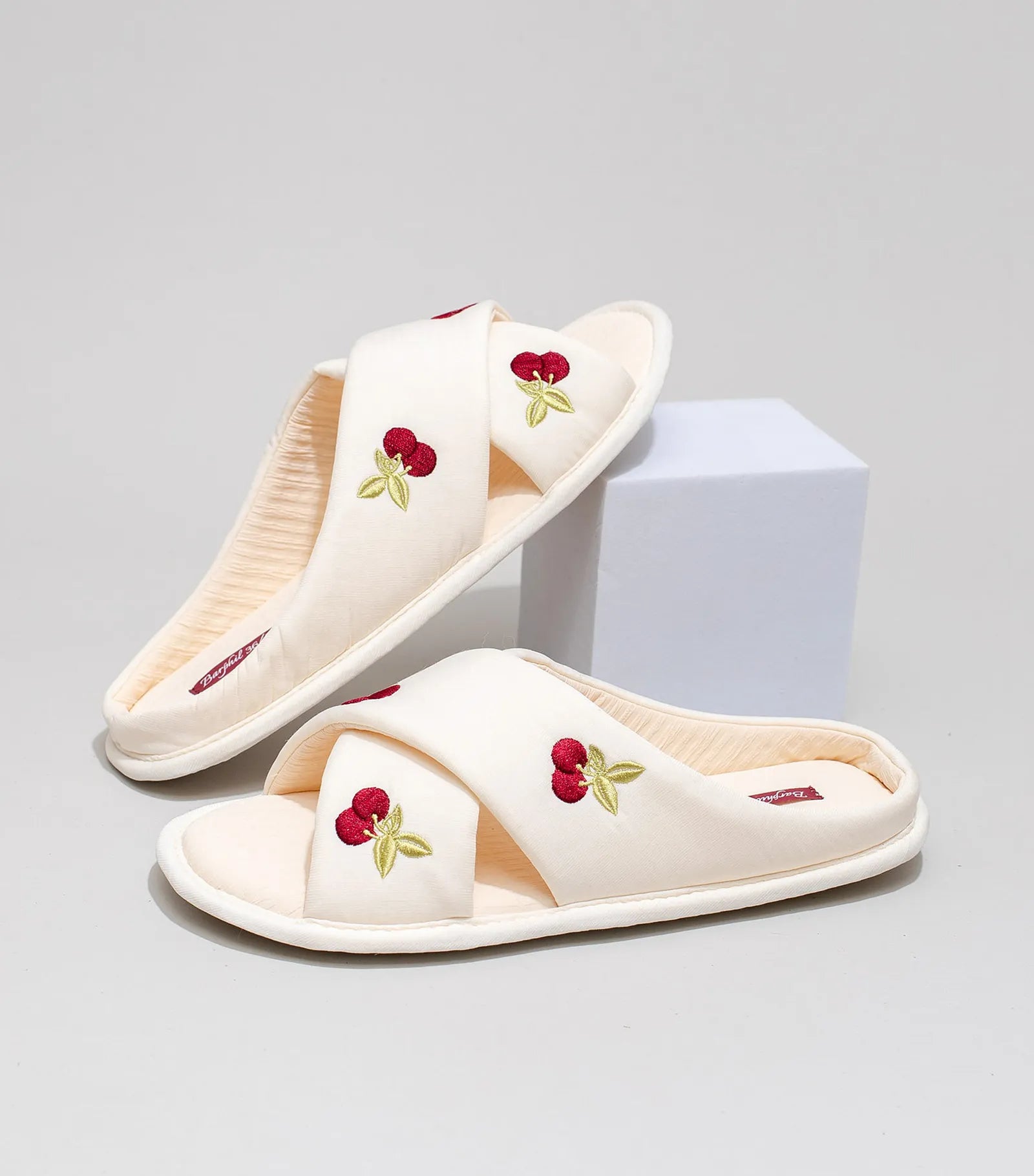 Side view of white cherry slides highlighting embroidered detail - RoomDen