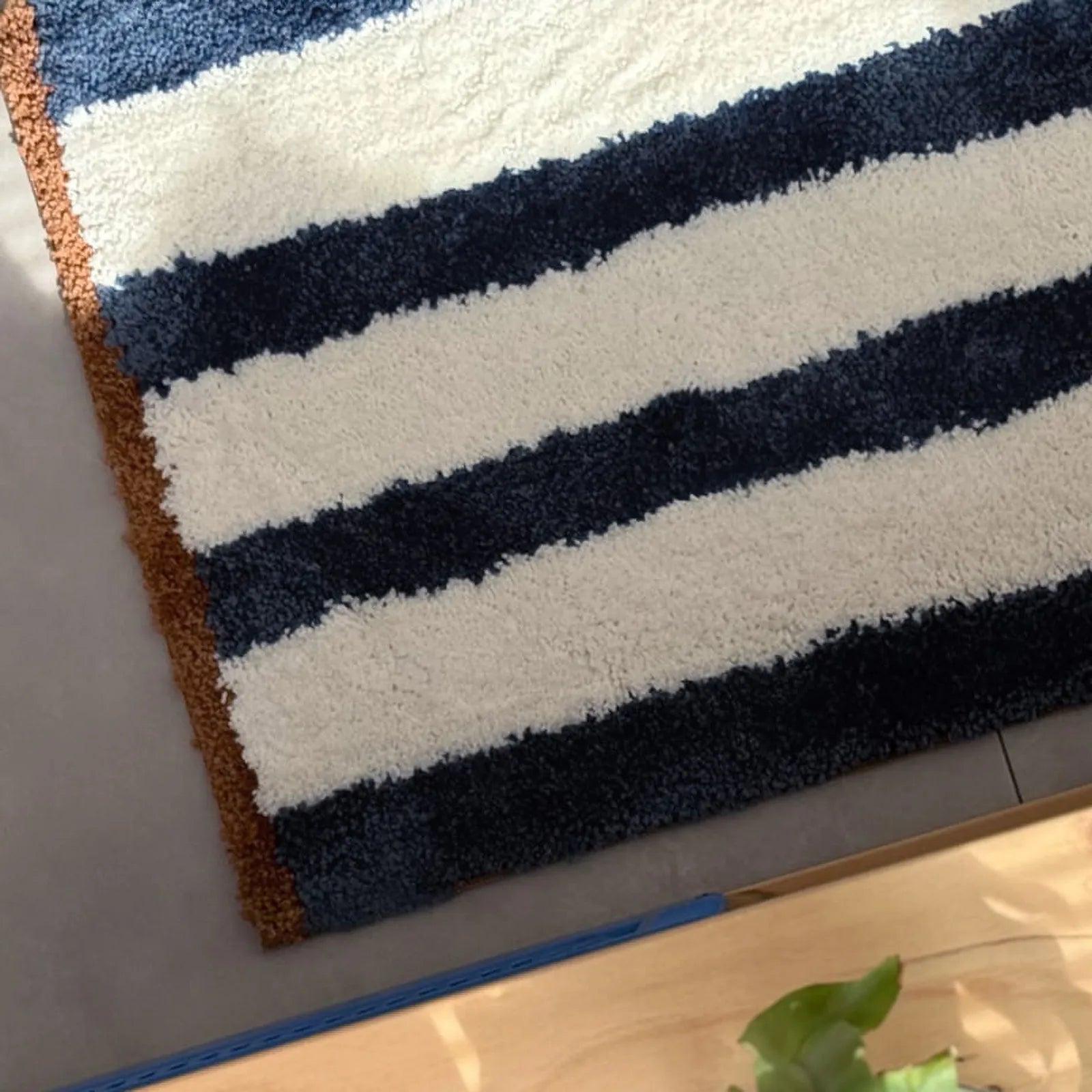Close-up texture view of blue and white shaggy rug pile - RoomDen