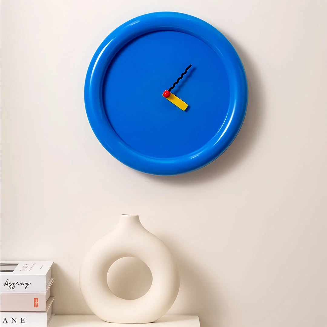 Cobalt Blue Chunky Frame Wall Clock on a wall with books and a modern vase - RoomDen
