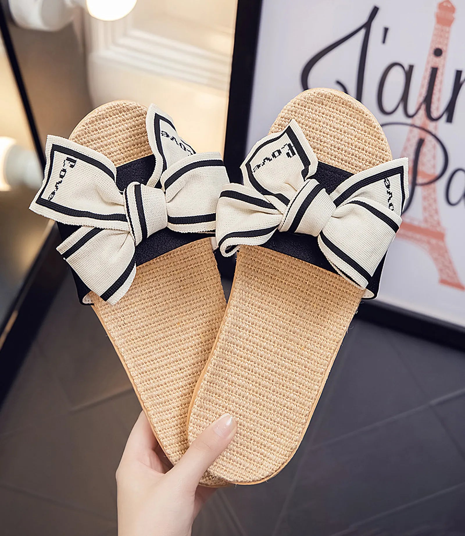 Hand holding pair of Black "Love" Bow Linen House Slippers - RoomDen