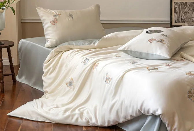 The bedding set shown with a lighter blue-grey sheet, demonstrating styling versatility.