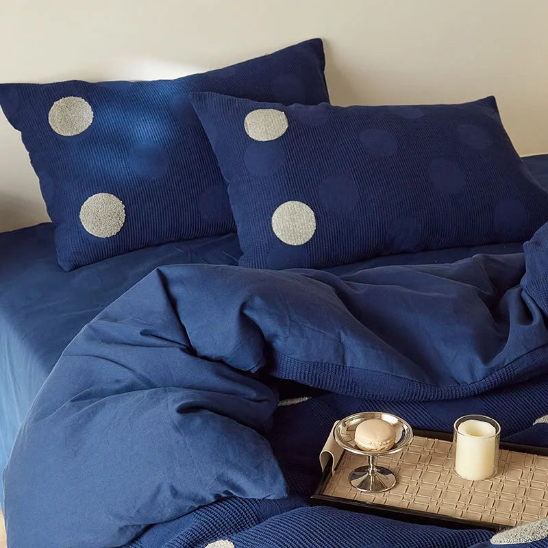 Detailed view of the Navy Polka Dot duvet cover and pillow shams, showing the soft folds of the fleece. - RoomDen