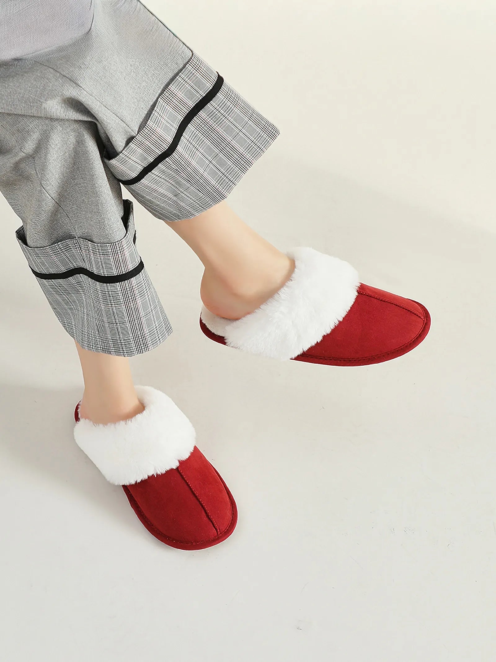 RoomDen Red House Slippers styled with plaid pajama pants showing faux fur trim.