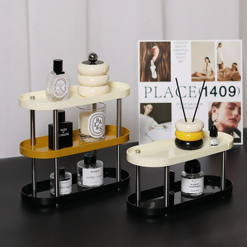 Multi-colored tiered vanity trays displaying perfumes and decor on a black desk. - RoomDen