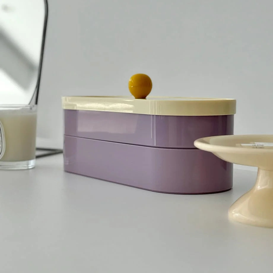 Close-up shot of the stackable lavender and cream makeup organizer, showing its sleek ABS finish.