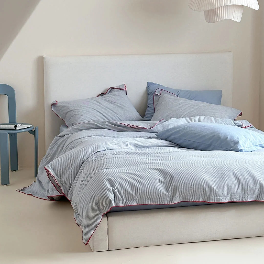 Angled view of the Light Grey & Red Pinstripe Washed Cotton Bedding Set, showing its soft texture.