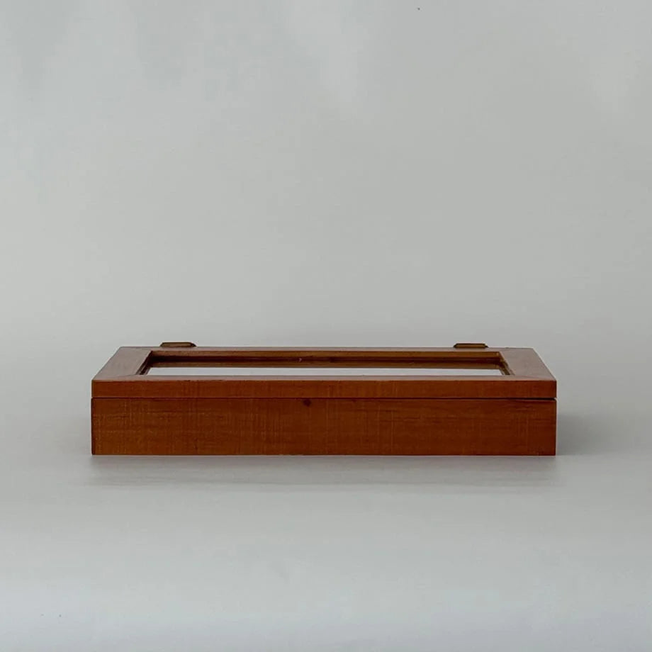 A front view of the closed walnut brown wood jewelry organizer against a plain white background.