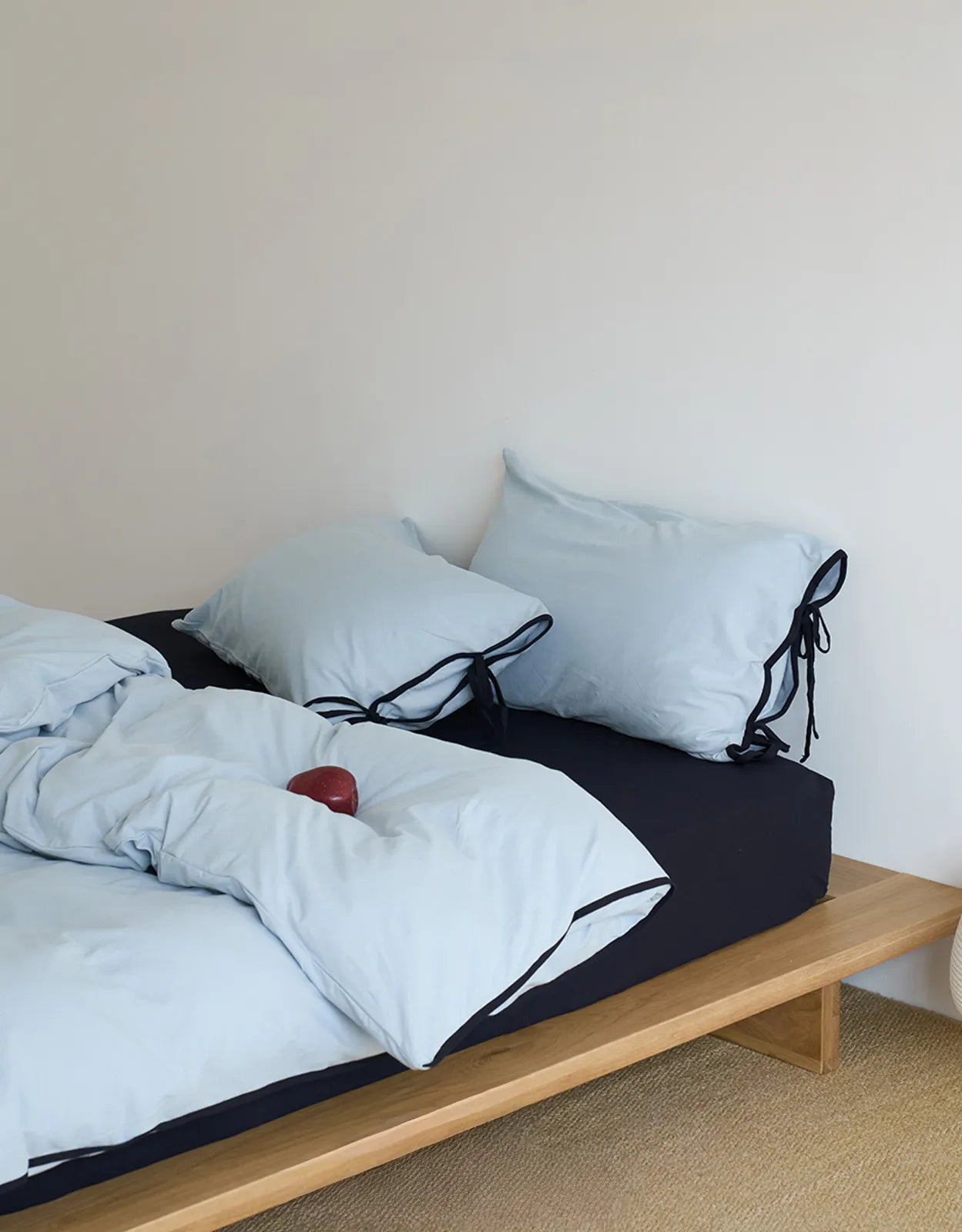 Sky Blue & Black variant of the Contrast Tie Washed Cotton Bedding Set on a wooden platform bed. - RoomDen