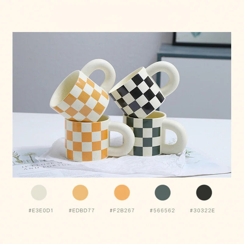 A collection of four checkered ceramic mugs in orange, black, and green, showcasing both Puffy and Oversized handle styles. - RoomDen