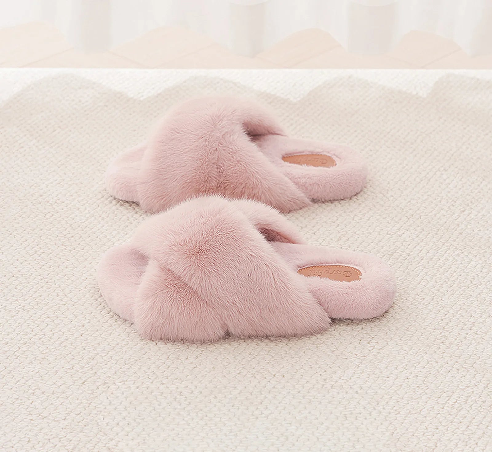Pink fuzzy cross-band slides on a soft textured rug - RoomDen