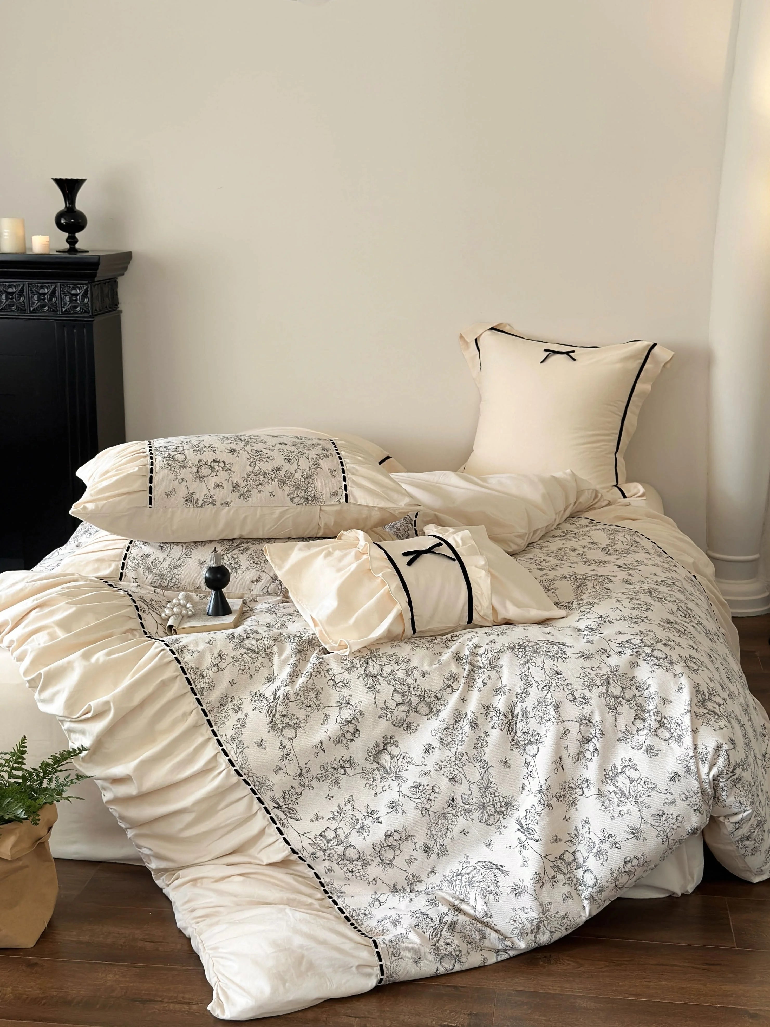 Angled view of the bed with the Cream Toile set, showing the room context with a black fireplace. - RoomDen
