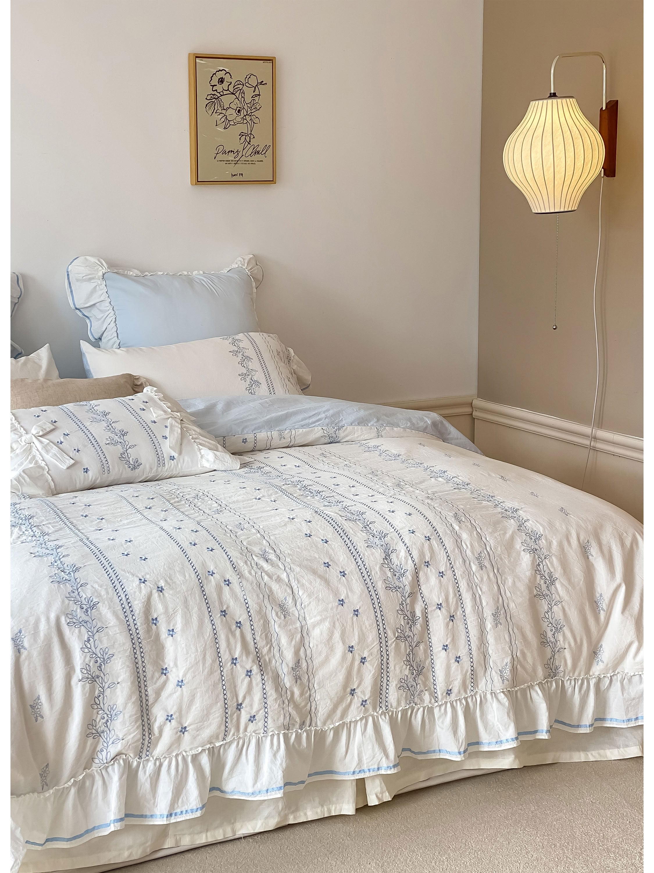 Light blue and white floral embroidered cotton bedding set with delicate ruffle edge and bow-tied pillowcases - RoomDen