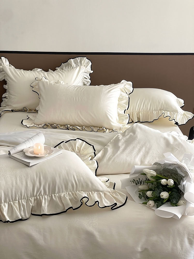Elegant white French ruffled bedding set with silky smooth texture and delicate lace pattern - RoomDen