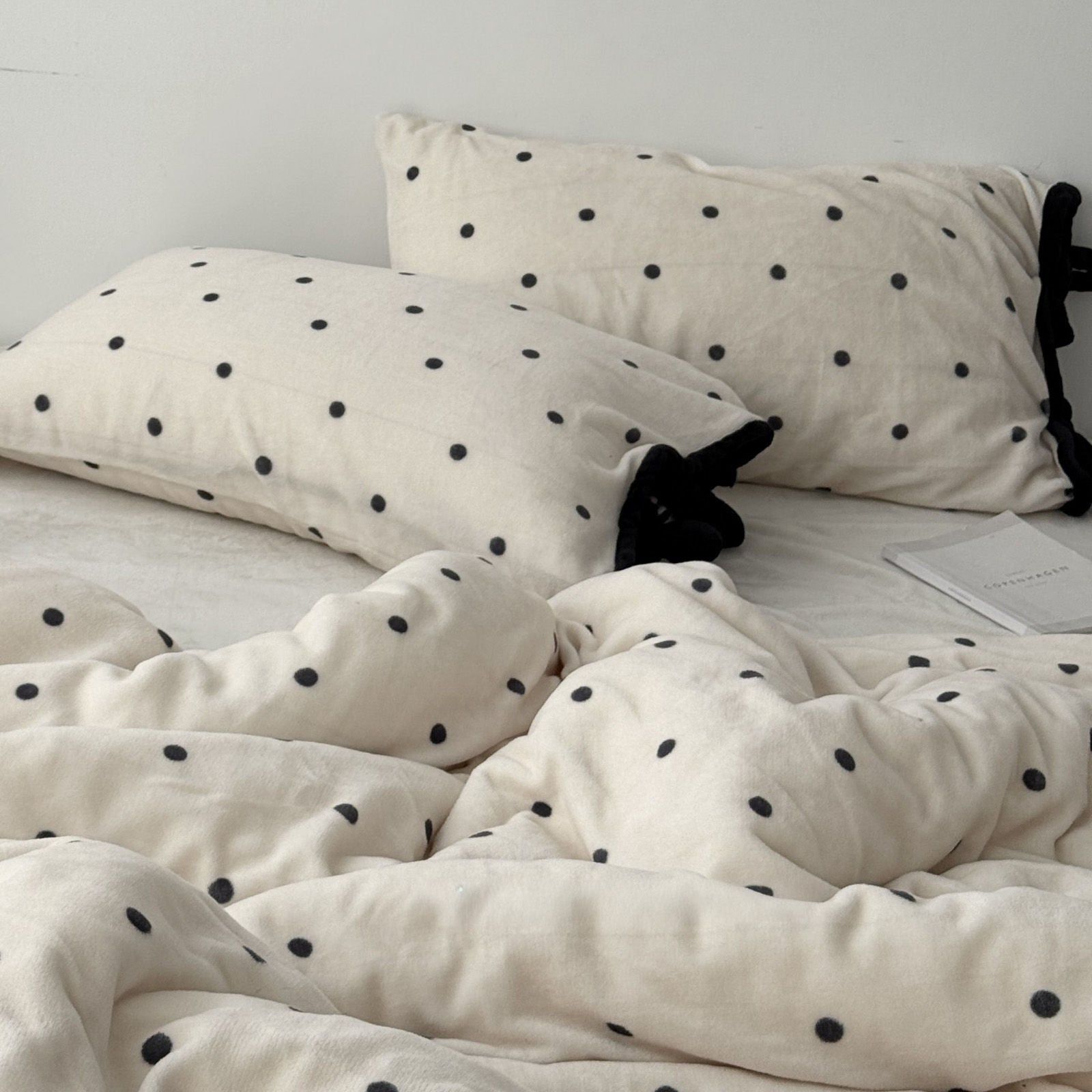 Aesthetic bedroom shot with cream and black polka dot fleece bedding RoomDen