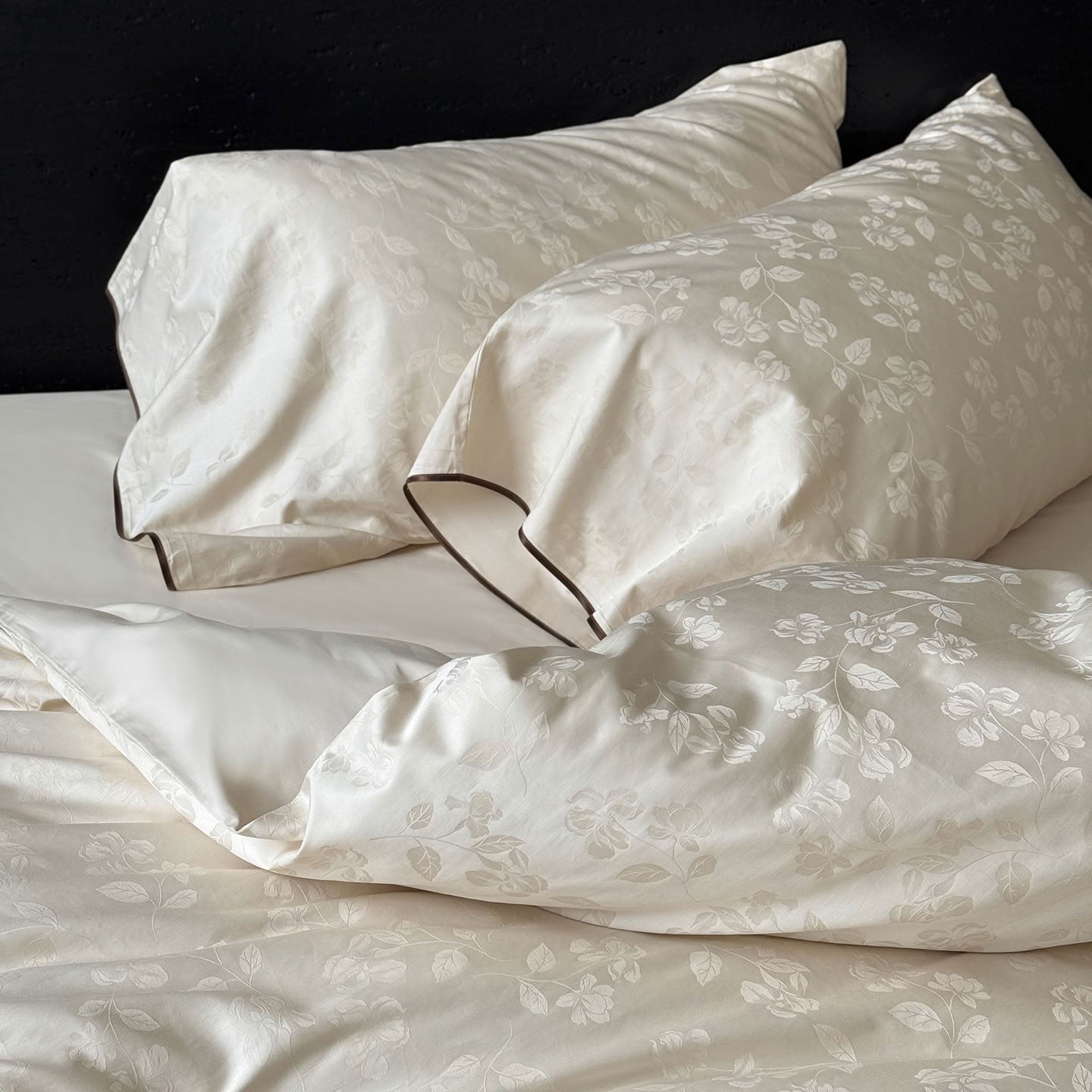 Pillowcases with raised jacquard floral detailing and brown piping – RoomDen