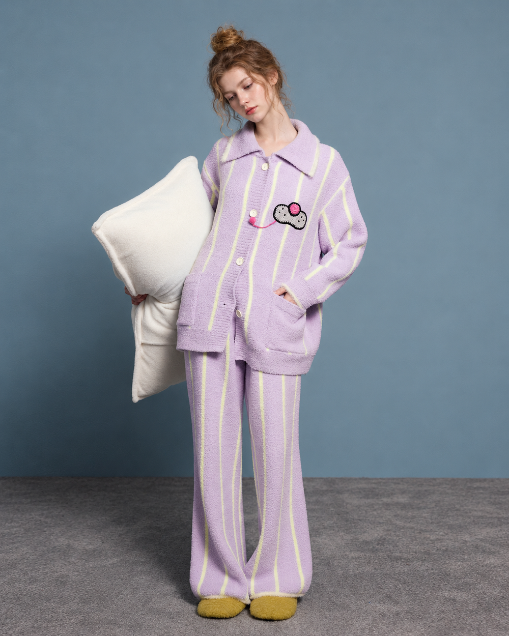 Striped Cat Motif Fleece Pajama Set – lavender, standing with a pillow - Roomden