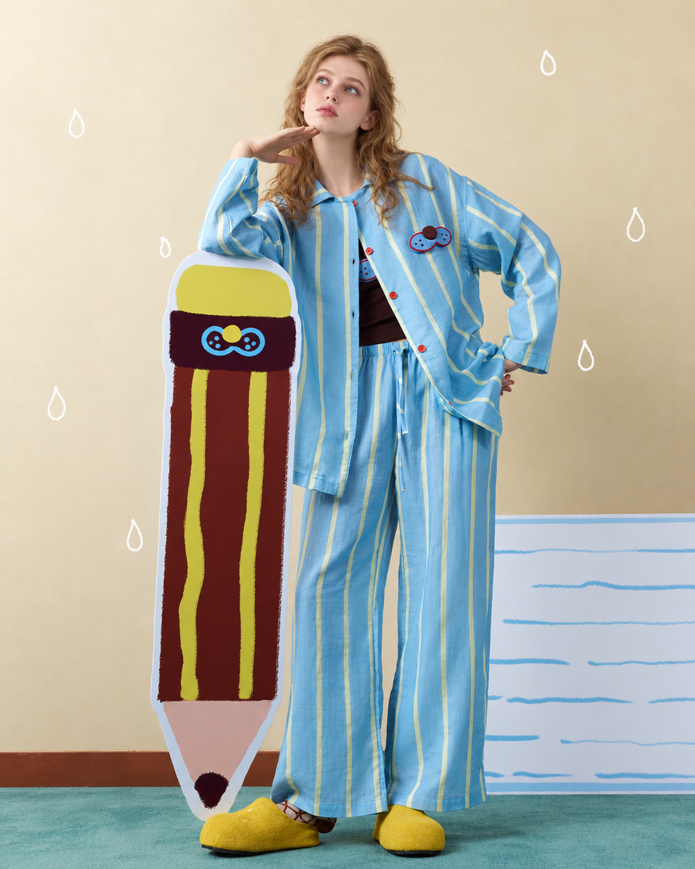 Striped Cotton Pajama Set – blue, yellow and white front view with a large pencil prop - Roomden