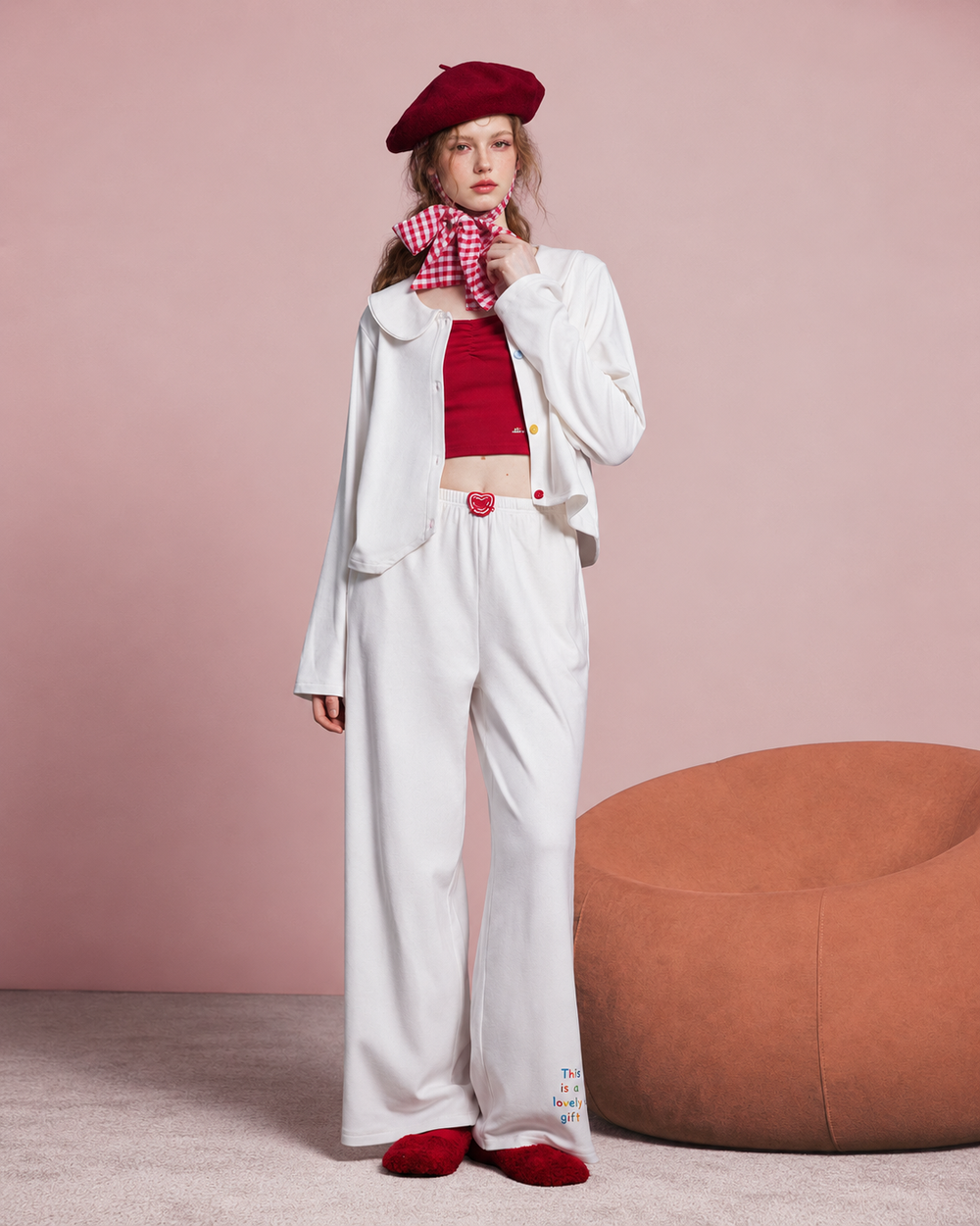 Front view of an ivory apple-detail pajama set with a Peter Pan collar and wide-leg trousers.