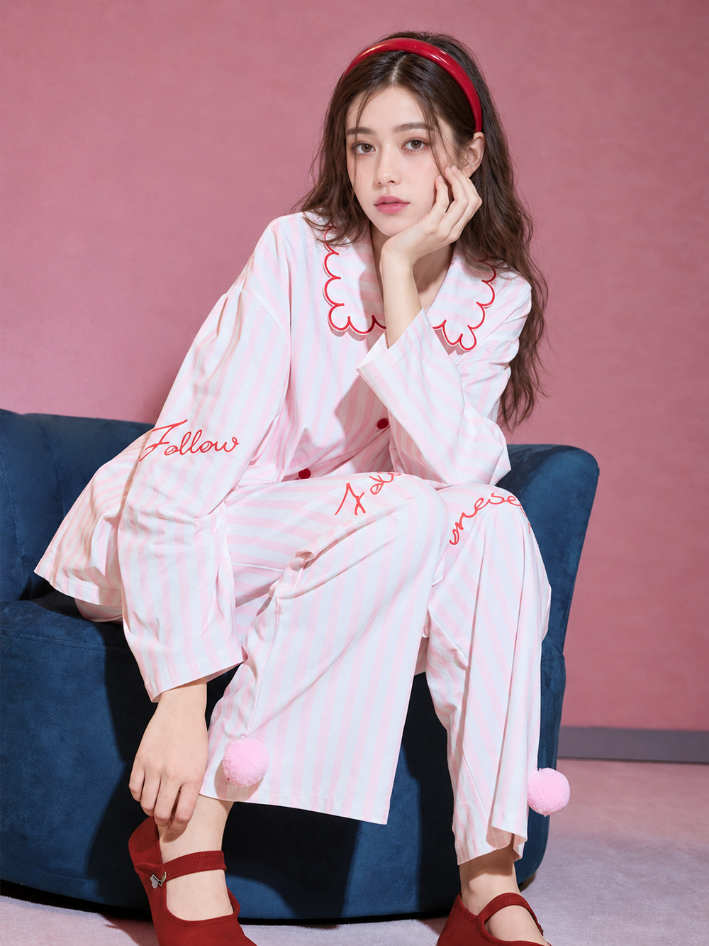 Scalloped Stripe Cotton Pajama Set – pink striped set seated on a blue chair - Roomden