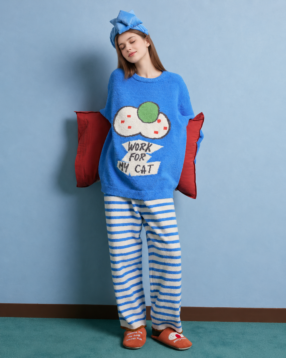 Blue cat graphic fleece pajama set with cream striped pants – Front view with red pillow