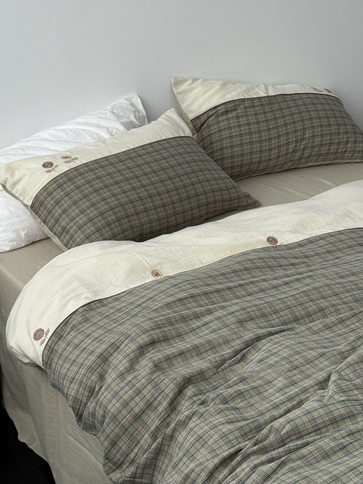 Green plaid and cream washed cotton bedding set with floral embroidery and button closure details. | RoomDen