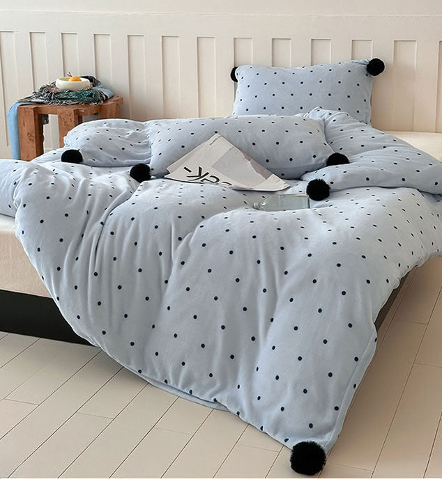 Cozy light blue polka dot bedding styled in minimalist bedroom - RoomDen