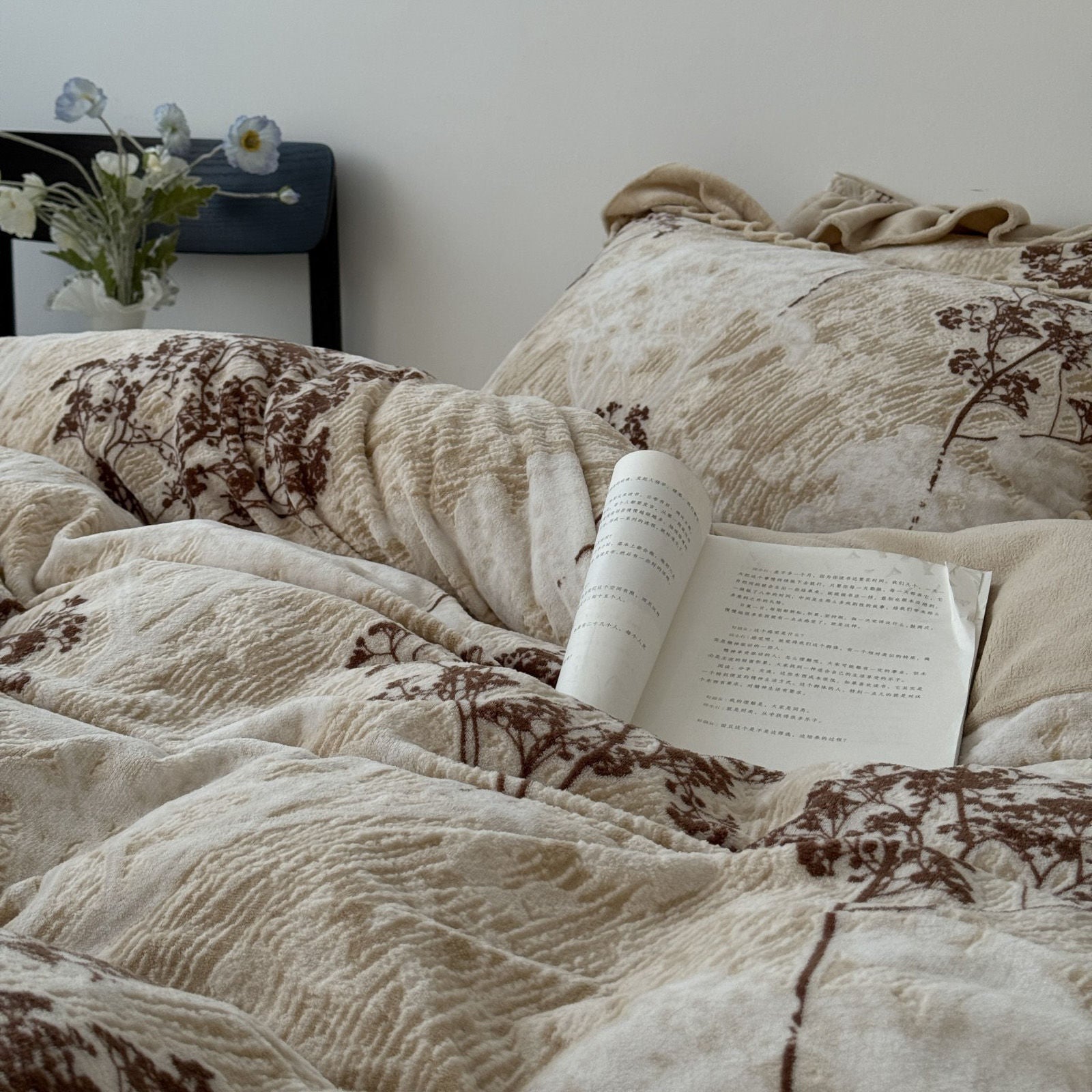 Side angle of the duvet cover showing the soft ruffles and vintage tree design on beige cotton. RoomDen.