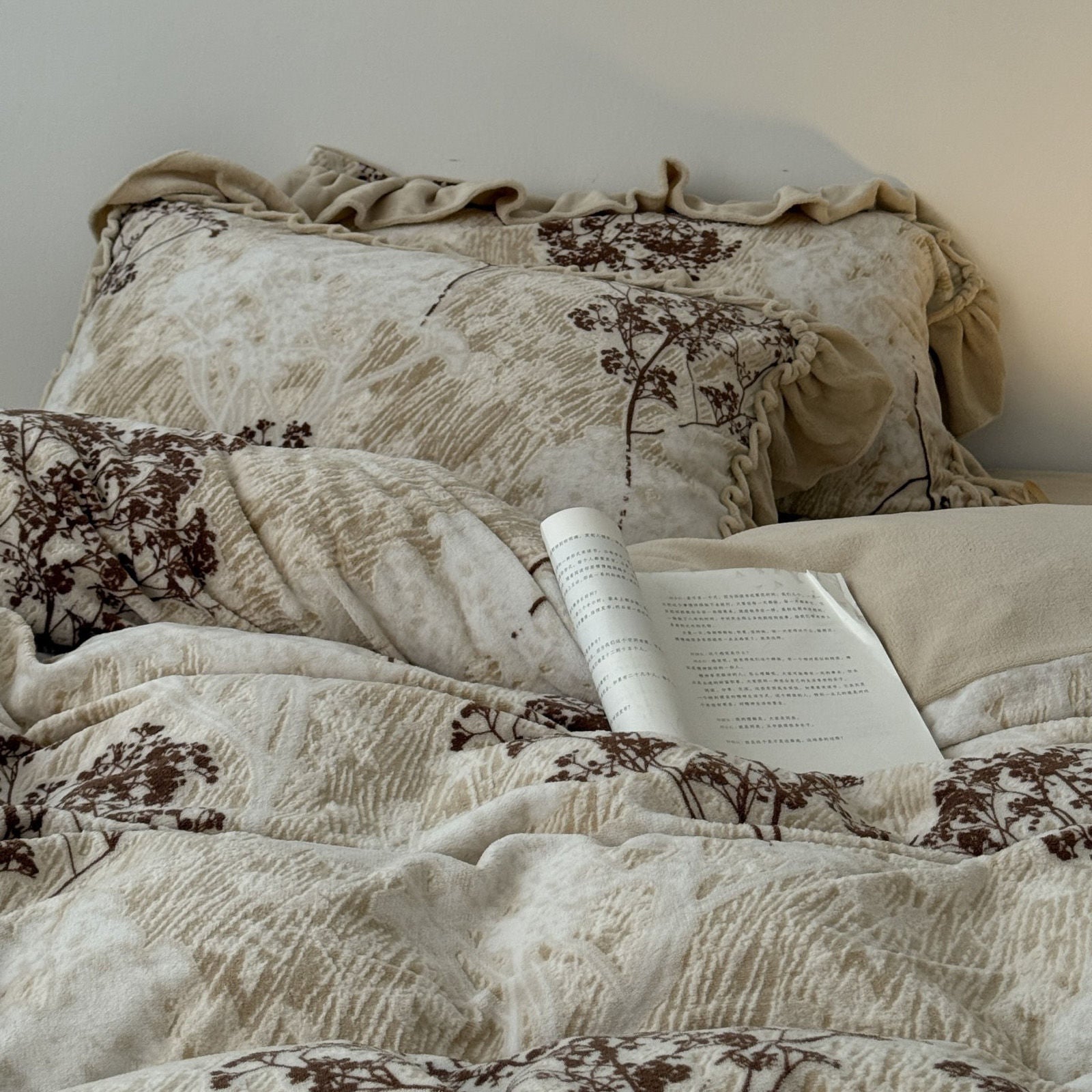 Lifestyle shot of the bedding set with an open book, highlighting the academia aesthetic and soft texture. RoomDen.