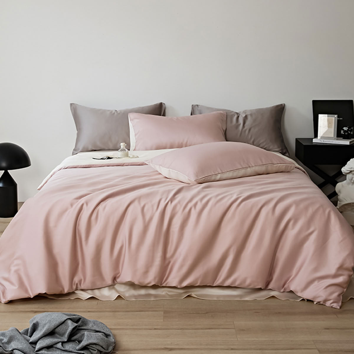 Soft blush pink and ivory reversible Tencel bedding set styled in minimalist bedroom – RoomDen