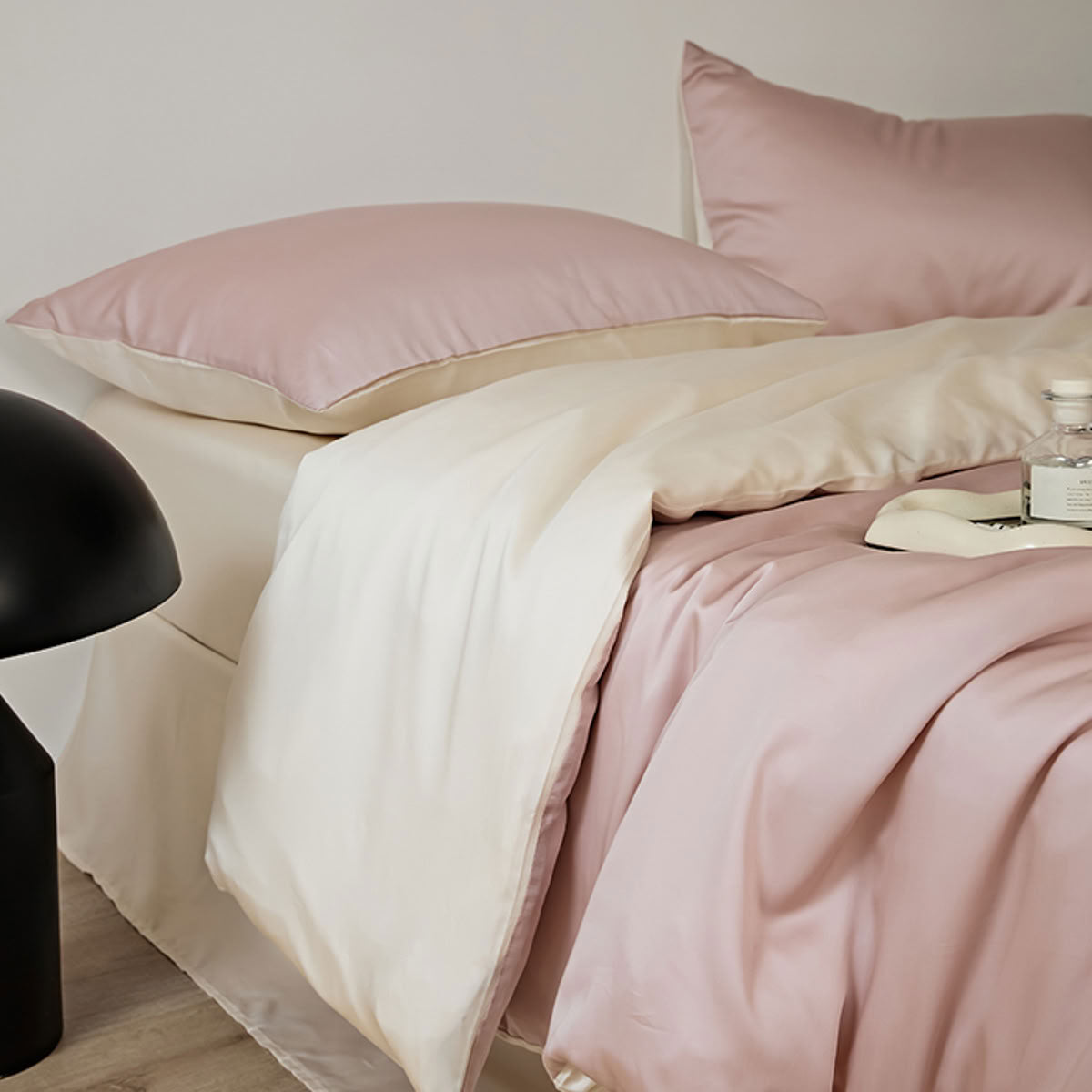 Close-up of silky blush pink Lyocell fabric with smooth cooling texture – RoomDen