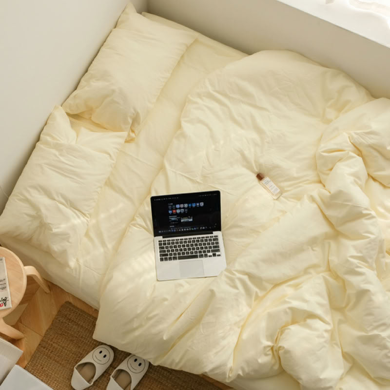 Soft beige washed cotton bedding set with a laptop on bed, creating a relaxed morning vibe - RoomDen