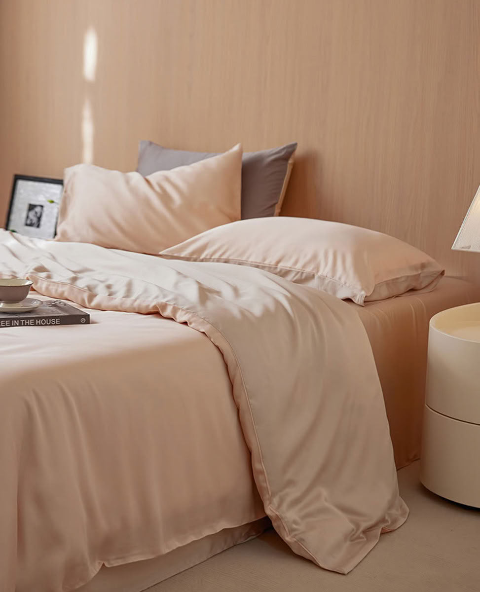 Minimalist bedroom view featuring beige-pink Tencel duvet and pillows against warm wood wall – RoomDen