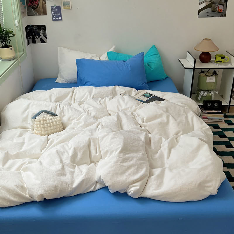 Two-tone white and blue bedding set styled with cozy morning light – RoomDen