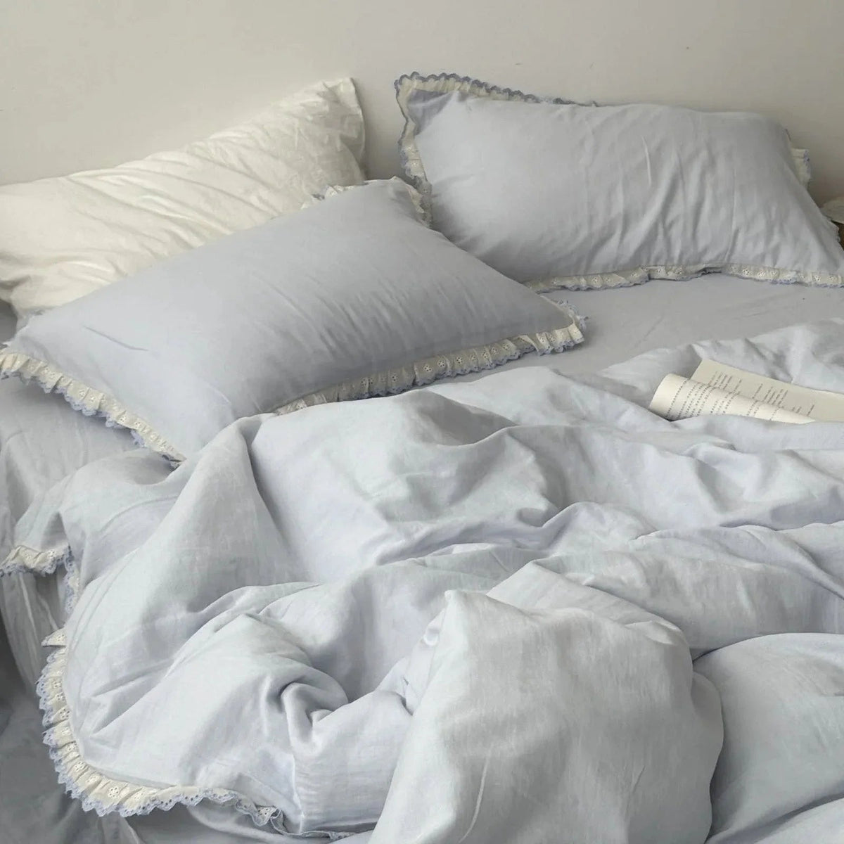 Soft Embroidered Lace Ruffle cottagecore bedding set styled on a cozy dorm bed — RoomDen