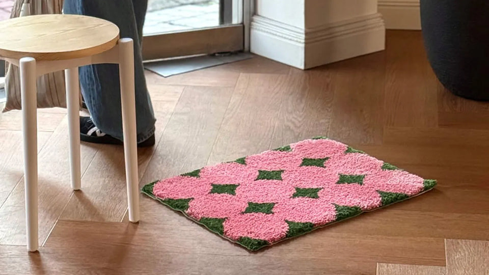 Aesthetic abstract wavy tufted accent rug used as a soft furnishing in a minimalist bedroom.