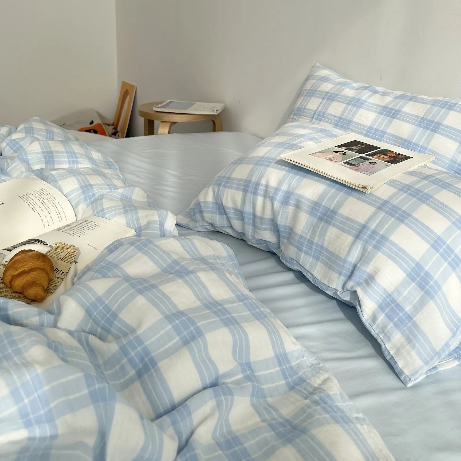 Hygge bedding set in soft neutral gingham plaid washed cotton on a cozy bed
