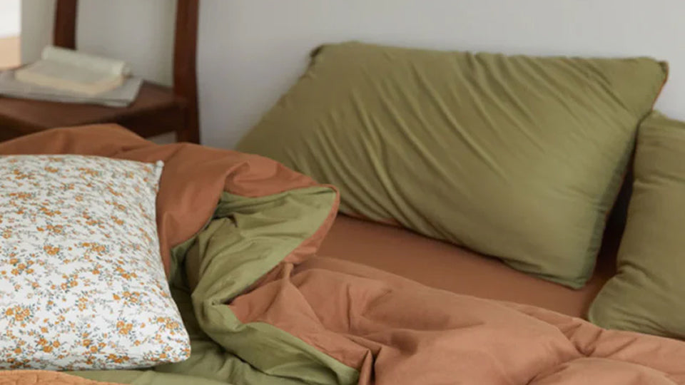 Neutral bedding scene, displaying the soft and serene feel of beige and cream tones.