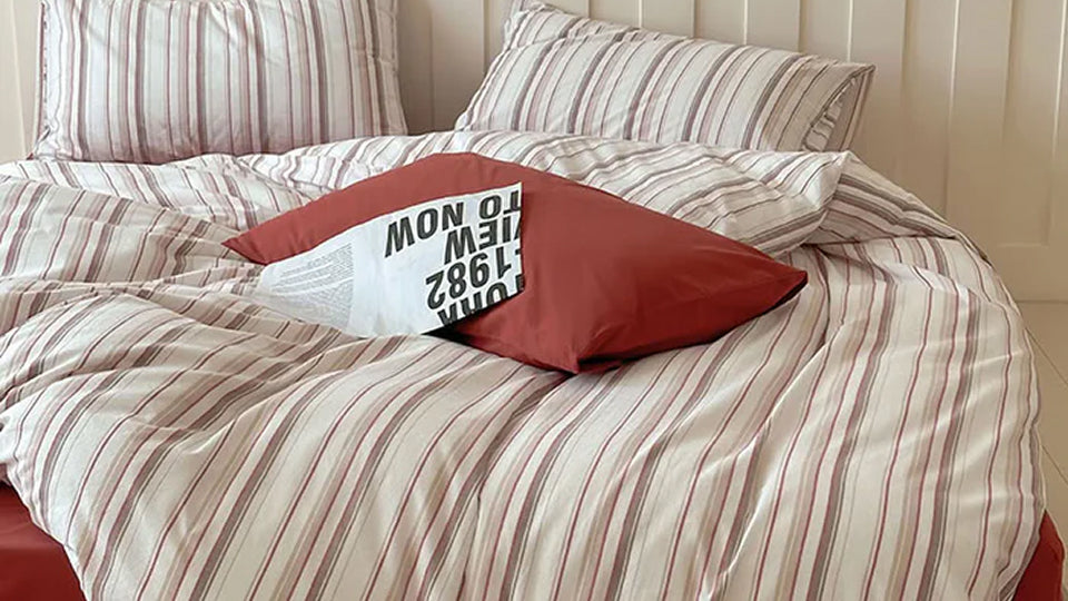 Close-up of classic striped bedding, showcasing clean lines and a modern feel.