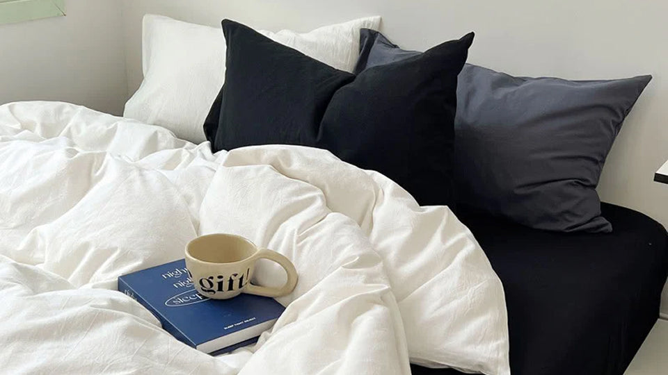 Close-up of washed cotton bedding, showing its natural wrinkles and relaxed, non-iron texture.