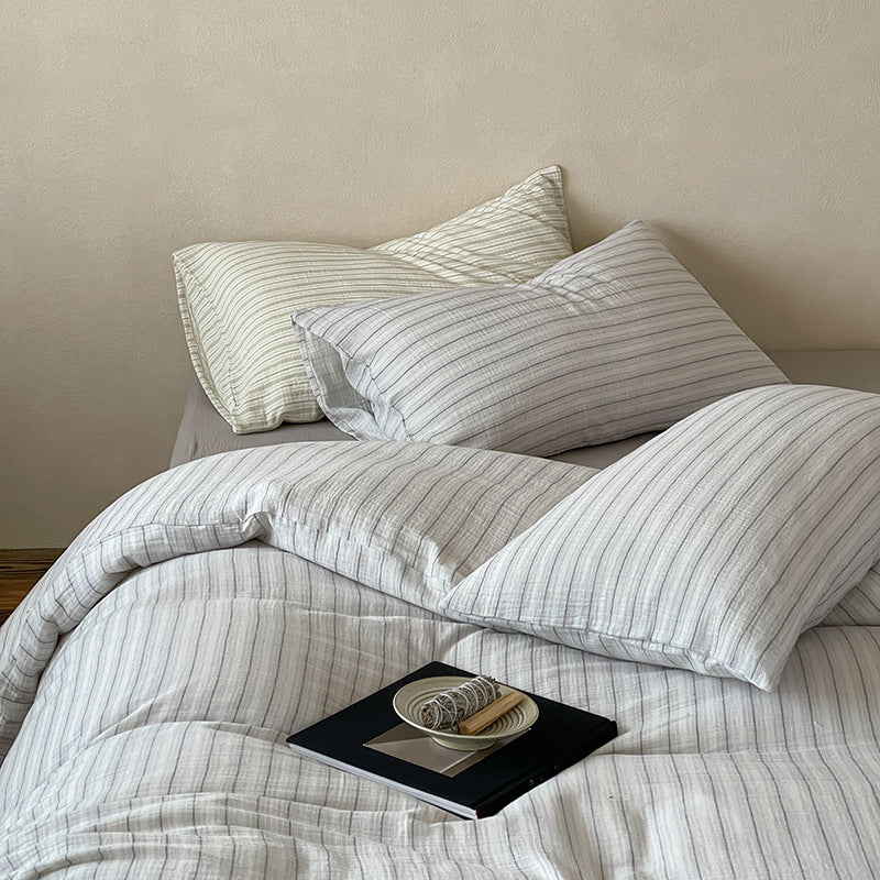 Halden Striped Cotton Double Gauze Bedding Set – near view of grey stripes and relaxed duvet folds with a tray - Roomden